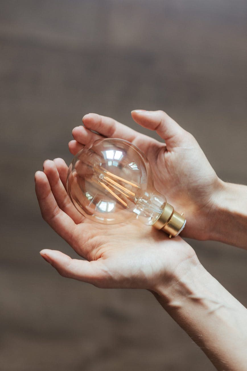 Hand holding lightbulb innovation